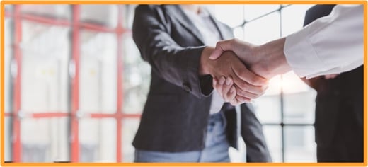 Two professionals shaking hands, illustrating partnership and personalized guidance in tax planning.