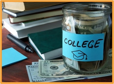 A glass jar labeled “College” filled with cash, surrounded by textbooks and dollar bills, symbolizes saving money for education using tax-advantaged 529 accounts.