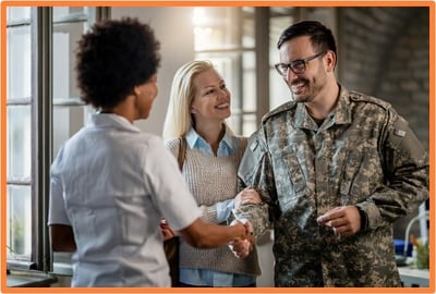Active-duty service member and spouse meeting with a financial advisor, representing the importance of understanding military tax benefits and financial planning.