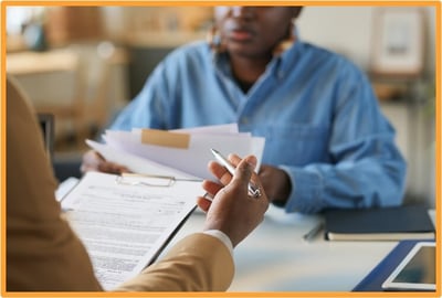 Business professionals reviewing IRS tax documents and discussing QPP depreciation rules, illustrating the importance of consulting tax advisors for compliance with new business tax regulations