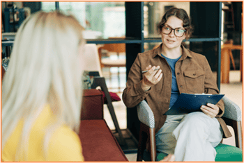 Alt text: Tax advisor discussing withholding and estimated tax strategies with a client, helping optimize their tax situation for the coming year.