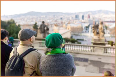 Retired couple enjoying a scenic city view while traveling, representing the lifestyle and possibilities that come with thoughtful retirement planning.