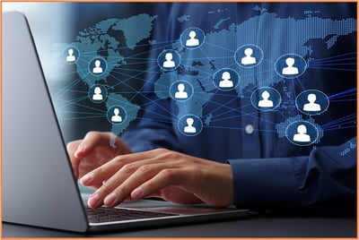 Business professional working on a laptop with a digital world map and connected icons, representing related business entities managing cross-border transfer pricing.