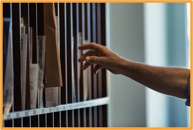"Person retrieving paper checks and mail from a mailbox, representing traditional methods of receiving federal payments that are being phased out.