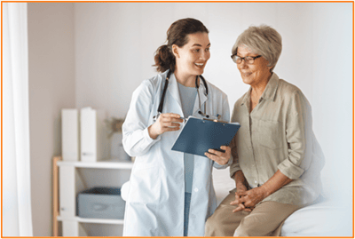 Doctor consulting with a senior woman during a medical appointment, highlighting the importance of planning for healthcare expenses in retirement.