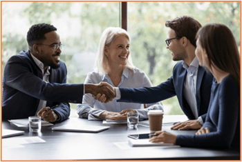 Business professionals meeting and shaking hands, symbolizing collaboration and expert guidance in tax planning and withholding adjustments.