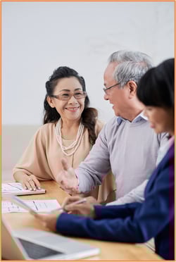 Married couple meeting with financial advisor to discuss spousal IRA contributions and retirement planning options