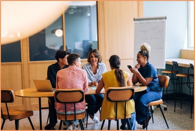 Small business owners and advisors having a collaborative meeting about succession planning and tax considerations, illustrating teamwork in planning an F reorganization.