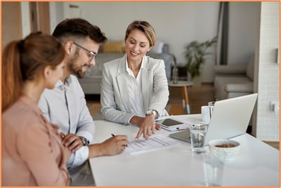 Married couple meeting with a financial advisor to review tax filing options and financial planning after their wedding.