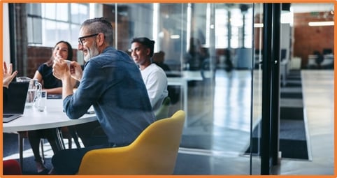 Business team meeting in a modern office, collaborating on tax planning strategies to maximize new depreciation and expensing benefits under the updated tax law.