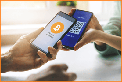 Two people completing a Bitcoin transaction using smartphones, illustrating how cryptocurrencies are used for digital payments and purchases.