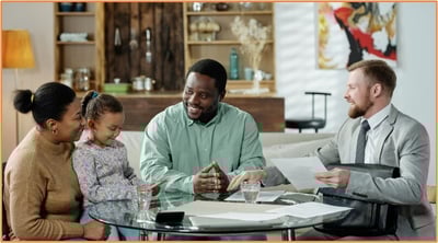 Family meeting with a financial advisor at home, illustrating the importance of professional guidance in estate planning and making informed decisions about tax implications for future generations.
