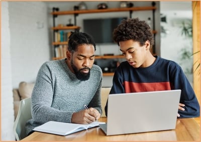 Parent and student working together on college financial planning at home, highlighting the importance of family involvement in managing college expenses and financial aid.