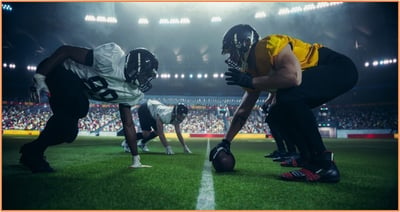 College football players lined up on the field for a game, representing student-athletes whose eligibility and finances are now impacted by NIL policies and evolving tax laws.